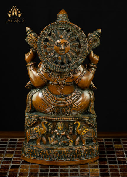 13" Lord Ganesh with Surya Halo seated on a pedestal with figurines of Ganesh and Lakshmi